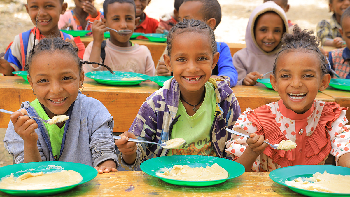Students in Tigray, Ethiopia enjoy a Mary’s Meal school meal. Students reportedly feeling hungry at school dropped from 72 per cent to zero per cent following the introduction of the program. Photo: Mary’s Meals.