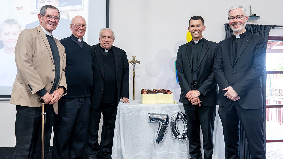 Joining in the cake cutting were Fr Greg Donovan, Ordinariate of Our Lady of the Southern Cross Ordinary Emeritus, Msgr Harry Entwistle, Fr Tim Deeter, Fr Mariusz Grzech and Fr Conor Steadman. Photo: Eric Odong/Archdiocese of Perth.