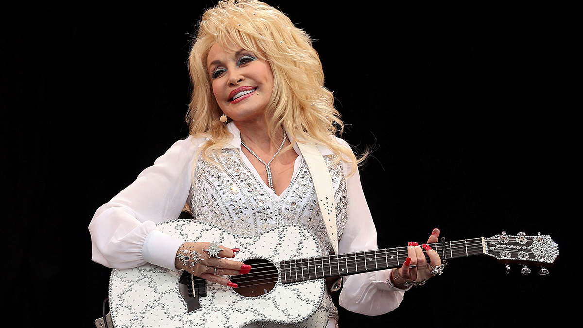 American country music star Dolly Parton performs on the Pyramid Stage at Worthy Farm in Somerset, England, during the Glastonbury Festival on 29 June 2014. The iconic singer-songwriter-actress, whose glittering country music stardom was matched by her pop fame and popular parallel careers in film and TV, died on 25 August 2026, at age 80, after a brief battle with cancer. Photo: OSV News/Cathal McNaughton, Reuters.