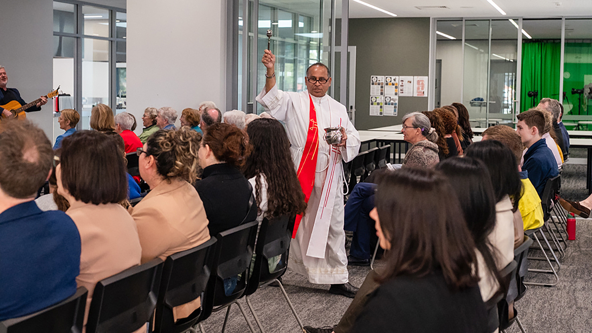 Girrawheen Parish Priest and Mercy College Chaplin Fr Albert Saminedi blesses the new facilities at Mercy College in Koondoola. The community had gathered to commemorate the 180th anniversary of the arrival of the Sisters of Mercy in Western Australia. Photo: Supplied.
